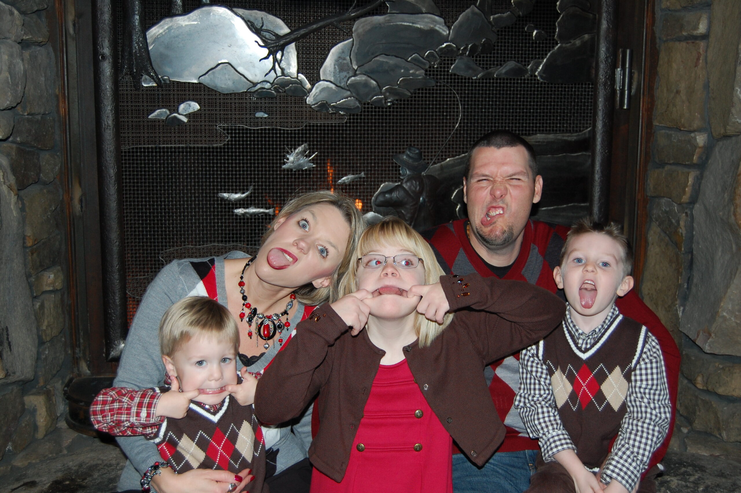 Shannon, her three children, and her husband making silly faces for a photo.