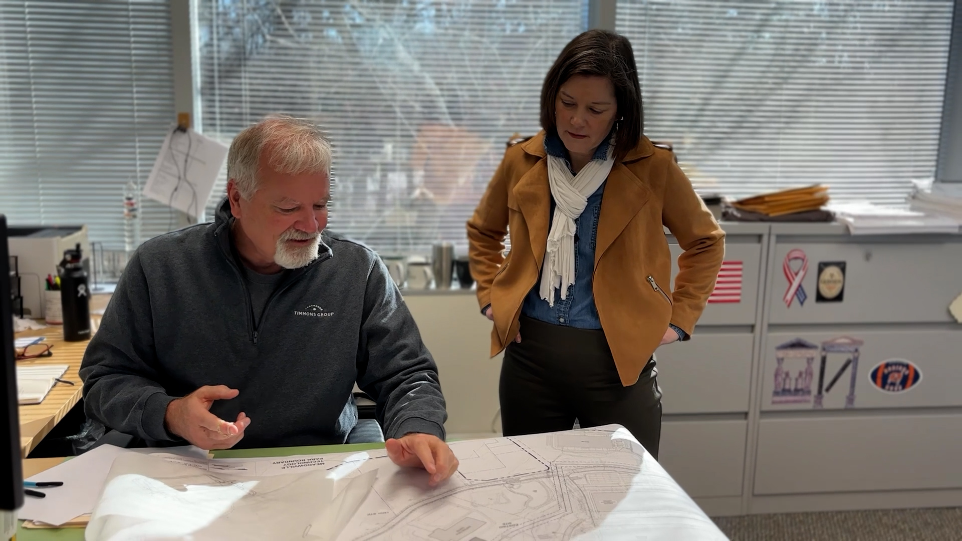 Heather looking at civil design plans with Timmons Group colleague.