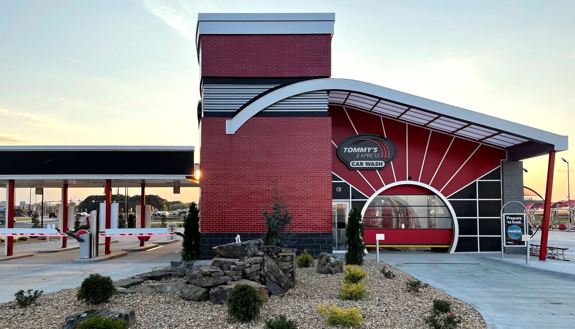 A striking red and black building with a vibrant red door, showcasing modern architectural design.