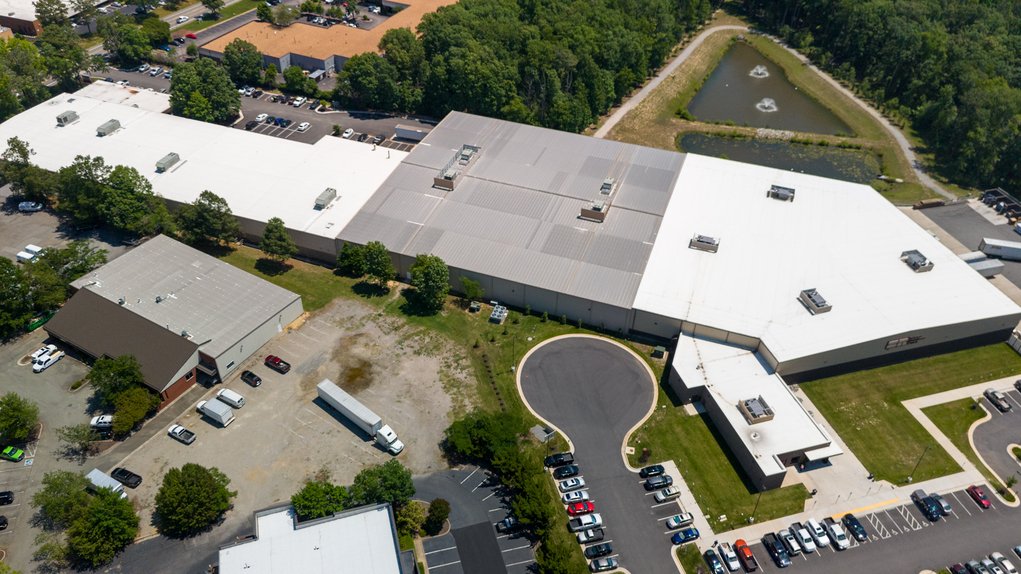 Aerial view of Super Radiator Coils, a 800,000 square-foot industrial facility, featuring the parking lot and surrounding operational areas.