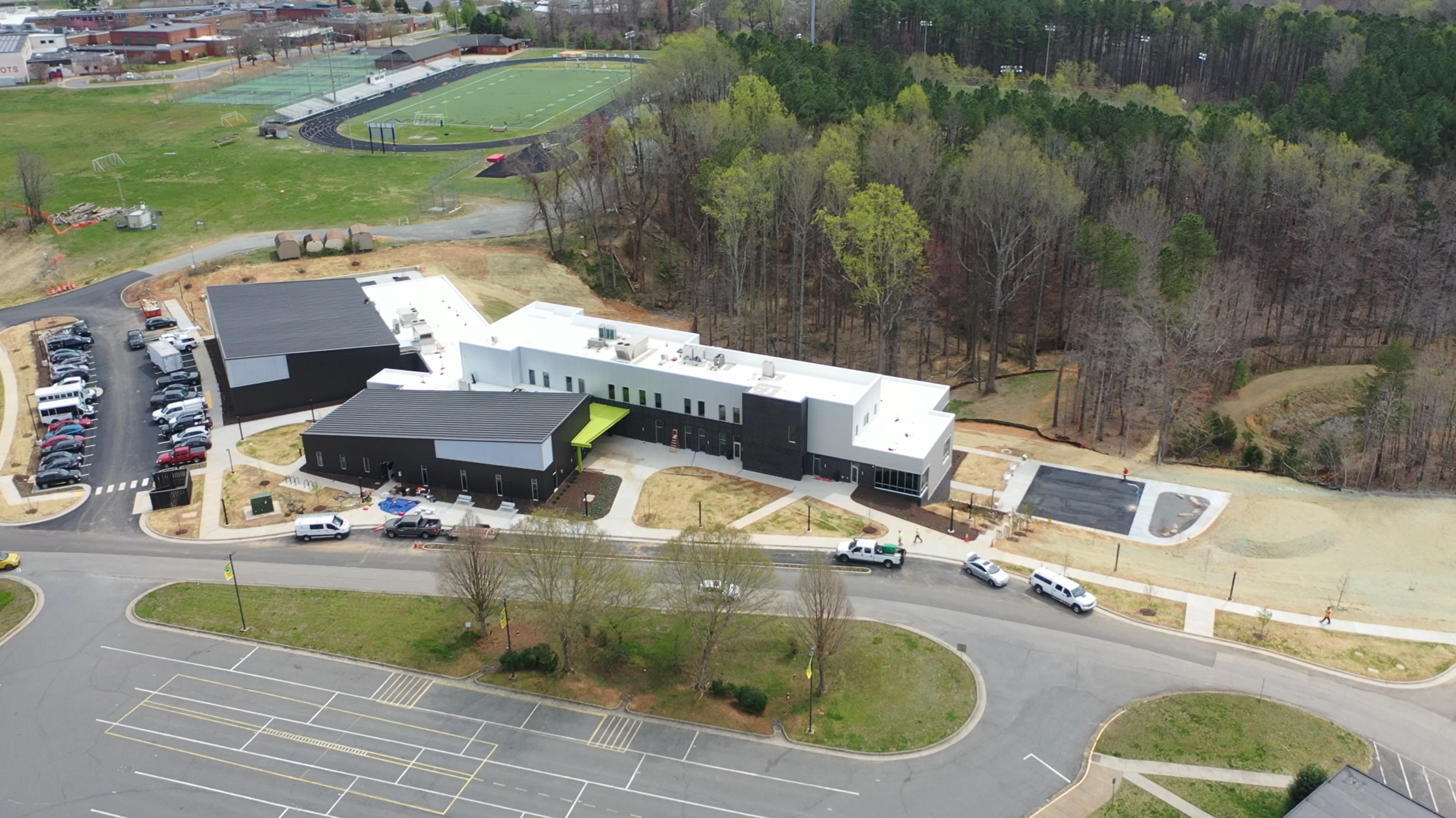Aerial photo of the white and black Albemarle Campus Club buildings.