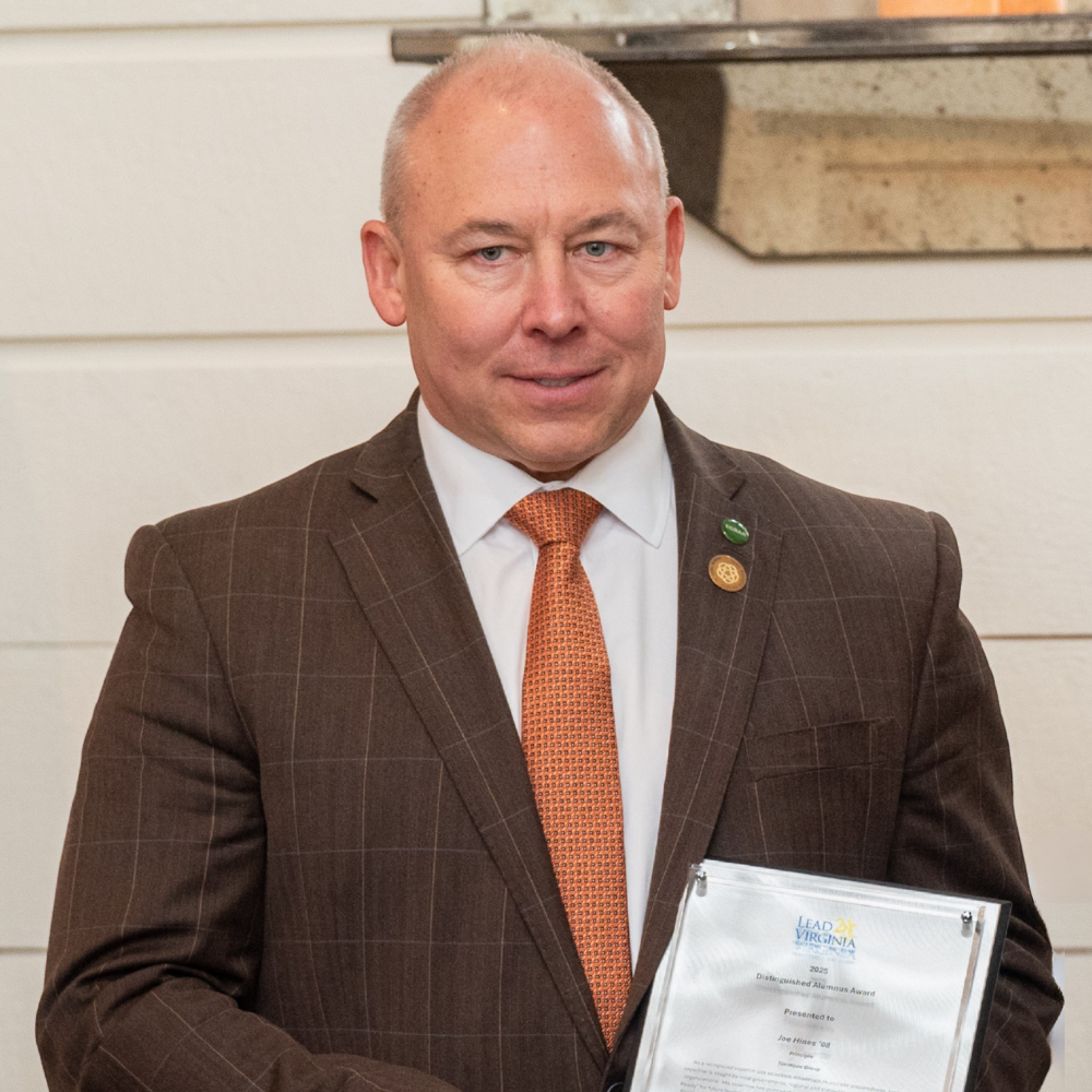 Photo of Joe Hines holding his Lead Virginia 2025 Distinguished Alumnus Award.