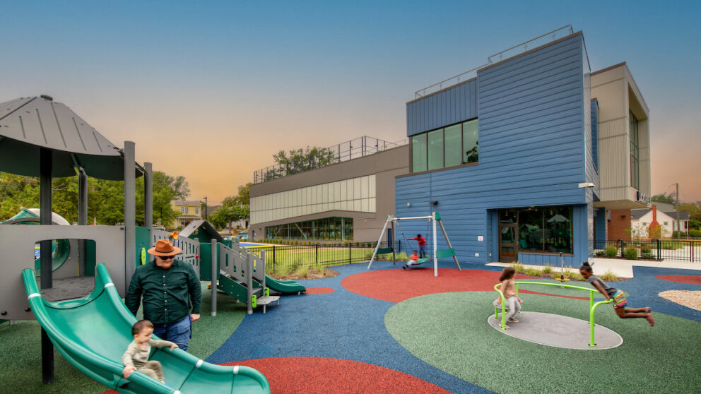 A rendering of children playing on a playground outside of the Lucks Field Community Center.