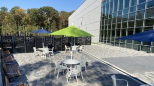 The patio on the side of the Feed More Headquarters, specifcally one table with chairs under an umbrella