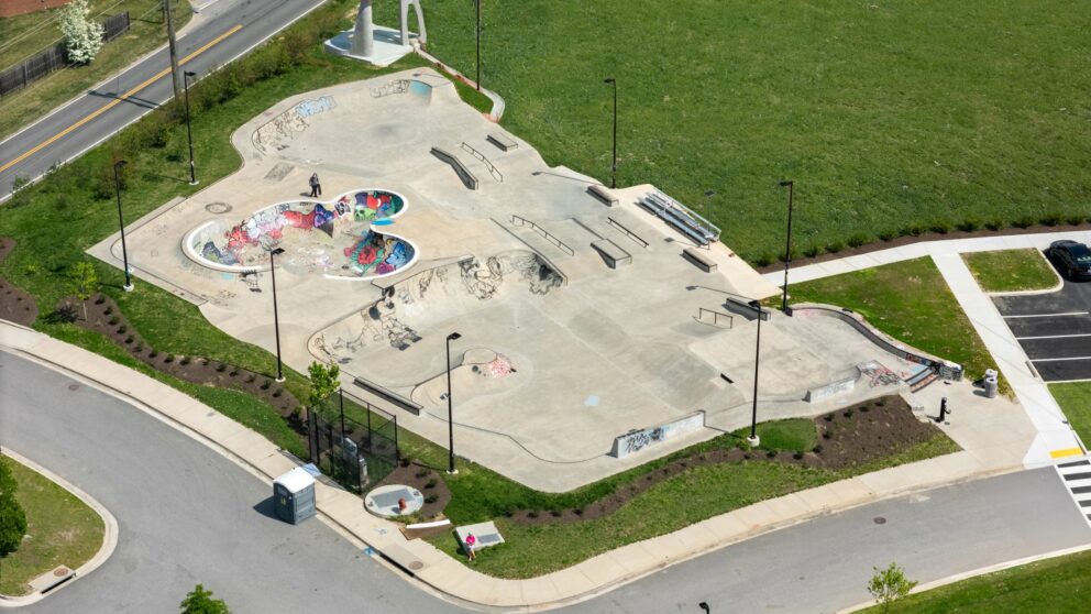 A concrete skate park in a grass lawn.