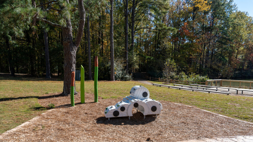A playground at the Three Lakes Park with a sculpture that looks like a cloud.