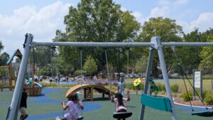 Children swinging on a swing set.