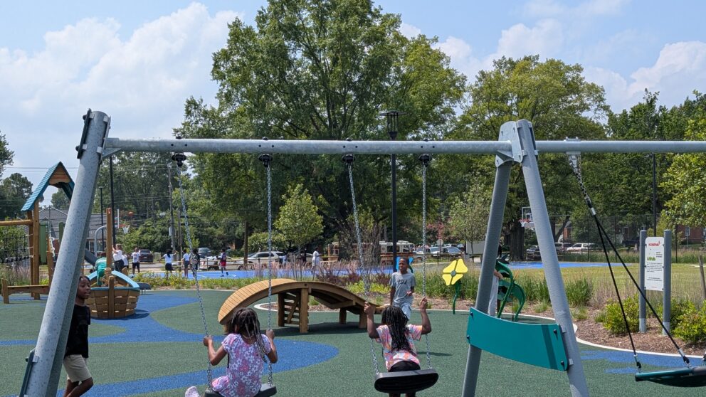 Children swinging on a swing set.