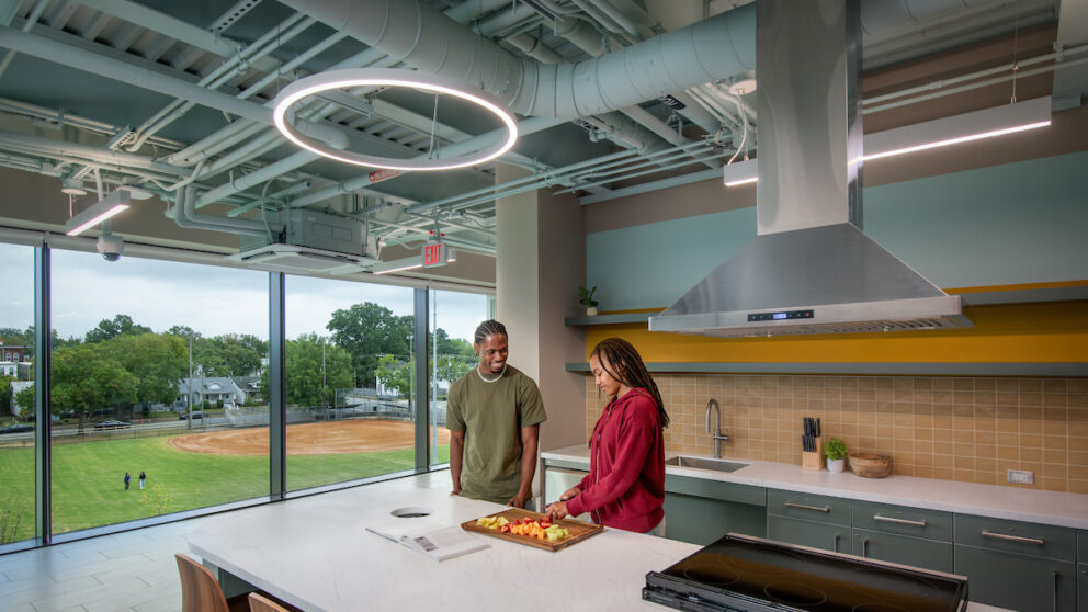 A rendering of two people cooking in a bar kitchen inside of the Lucks Field Community Center.